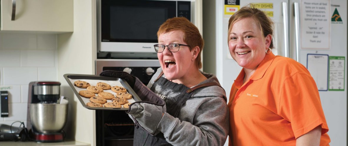 two happy people in kitchen baking cookies